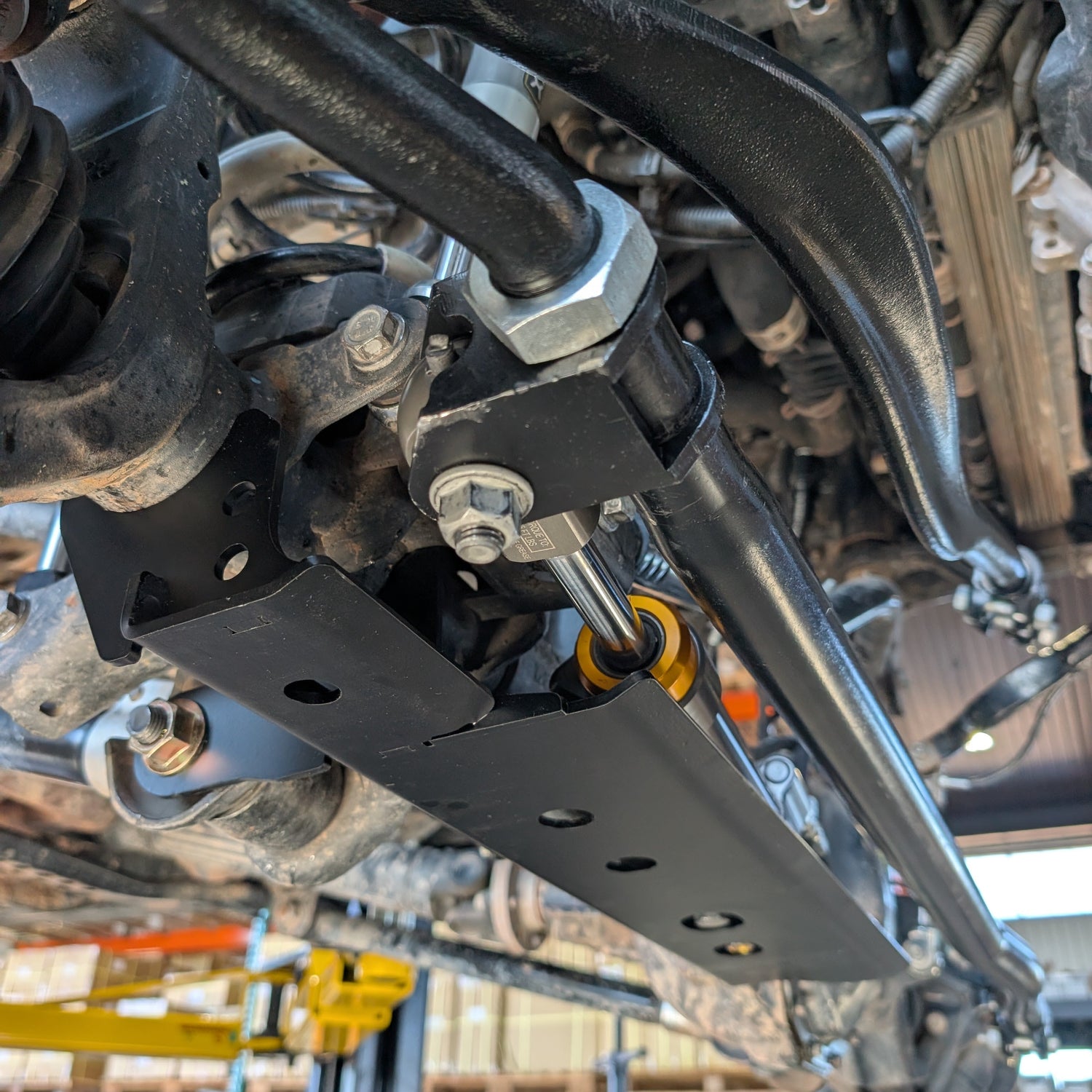 Close-up of RockJock Tie Rod Mounting Bracket with the Apex Through Shaft Steering Ram